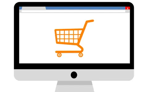 Monitor z ikoną koszyka zakupowego, symbolizujący branżę e-commerce i zakupy online.